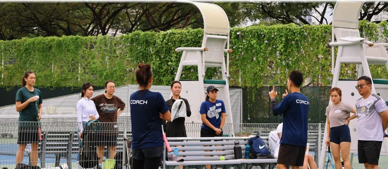 Tennis lesson participants practicing forehands