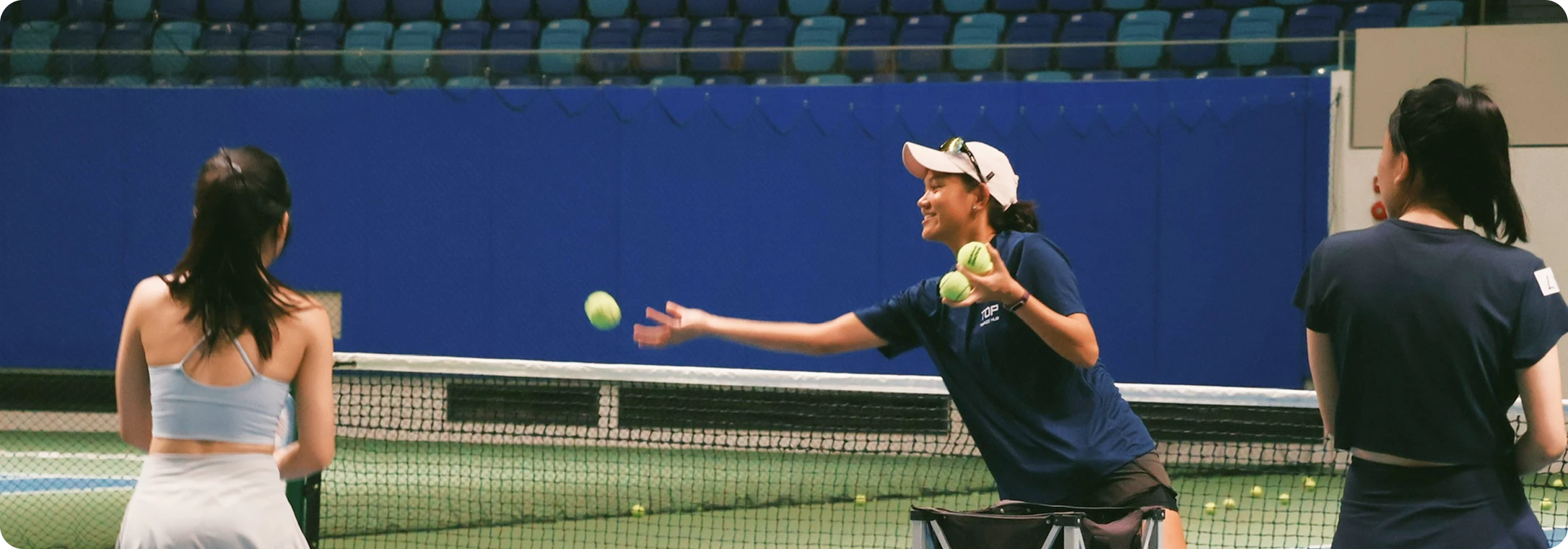 Professional tennis coach guiding player during practice session