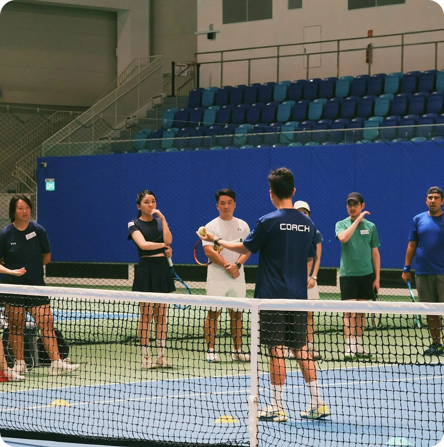 Professional tennis coach guiding player during practice session